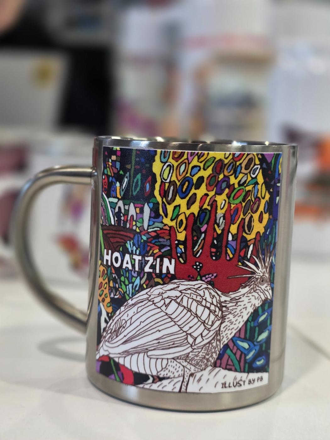 Mug featuring Phoenix Brown’s colourful HOATZIN bird artwork