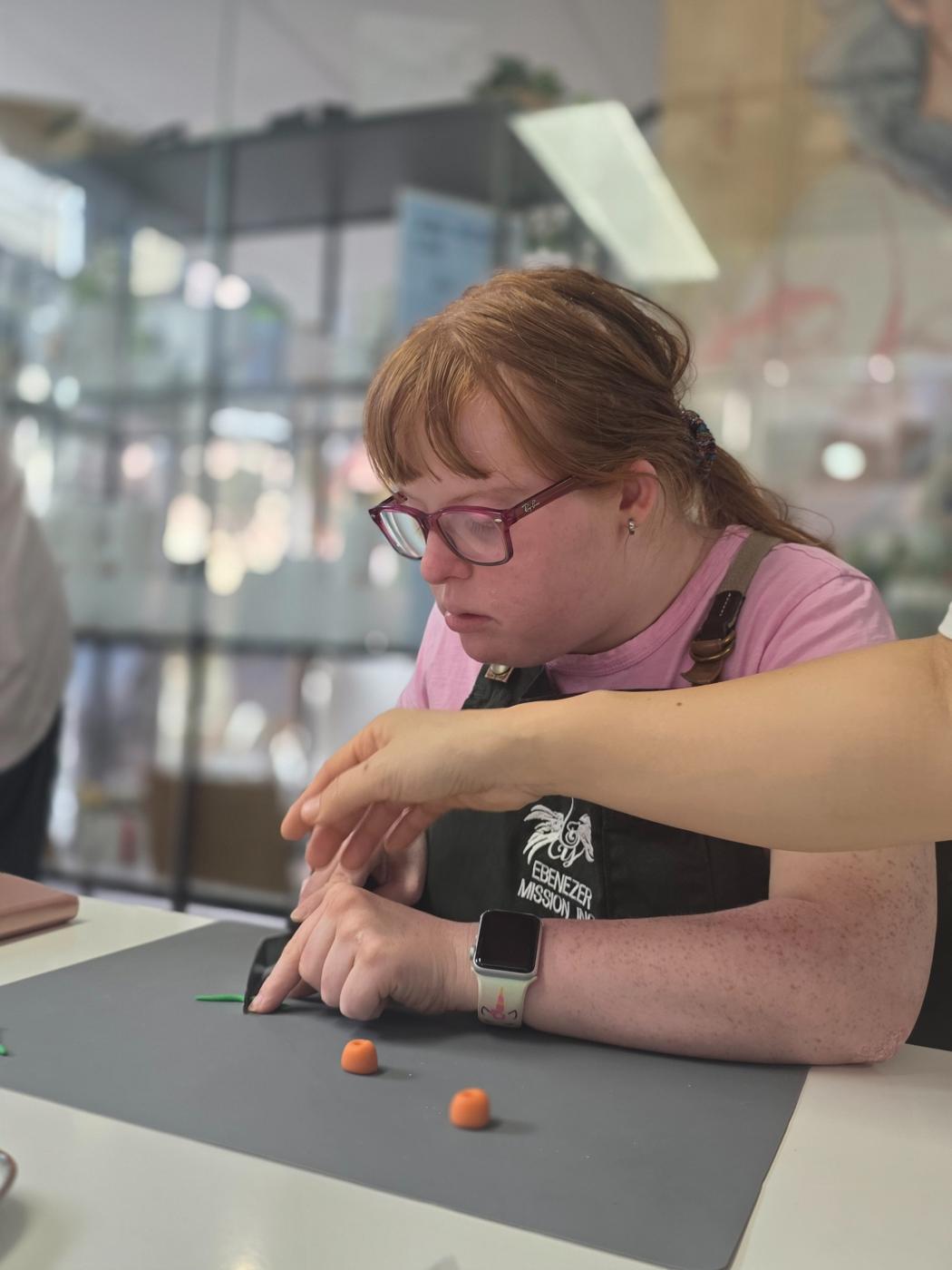 Participant shaping small decorations during a creative baking session
