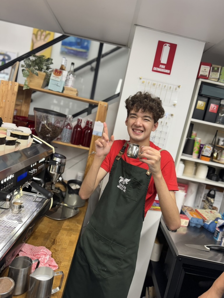 A young barista developing practical coffee skills at Eben Coffee House