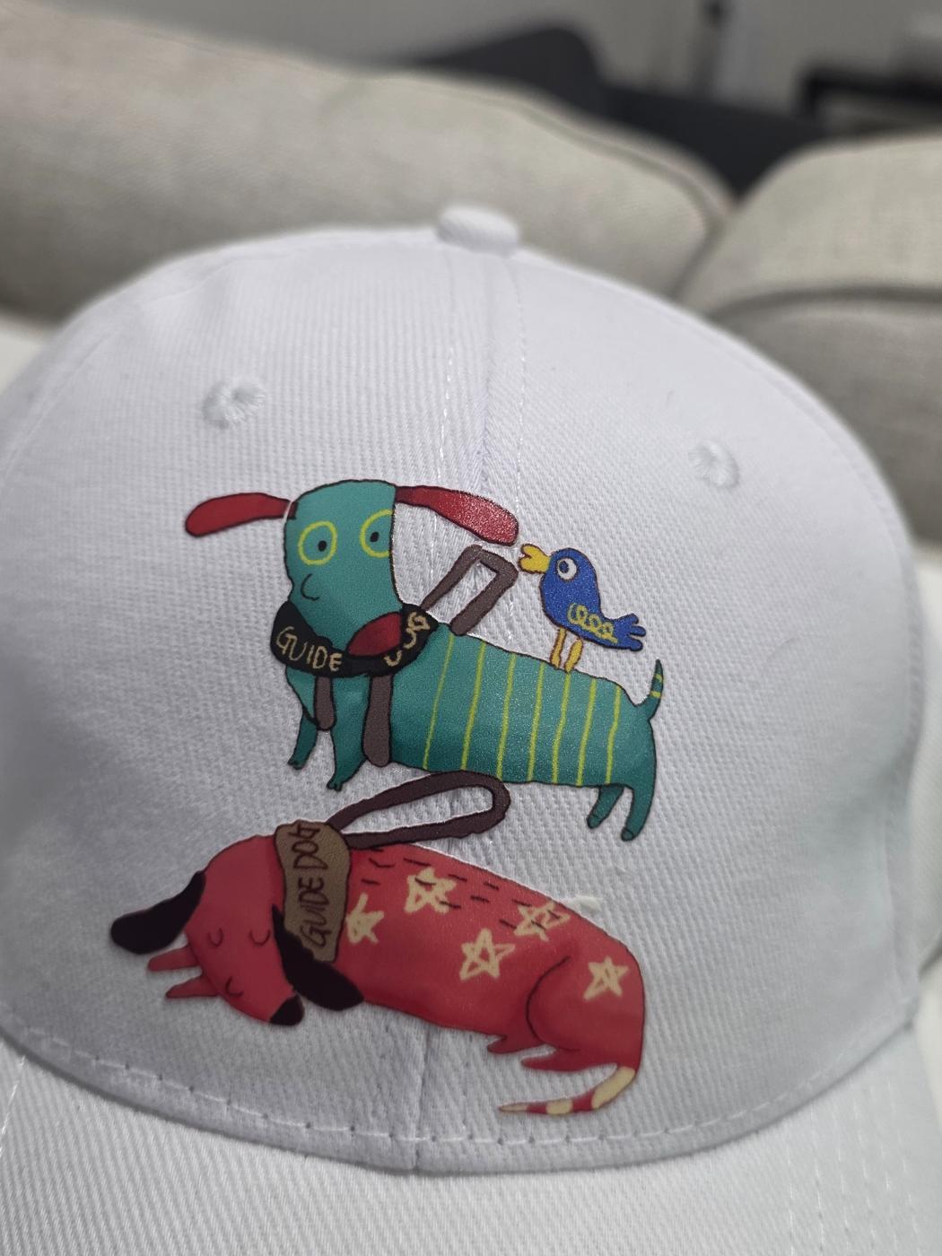 Cap featuring a guide dog illustration by an artist with disability
