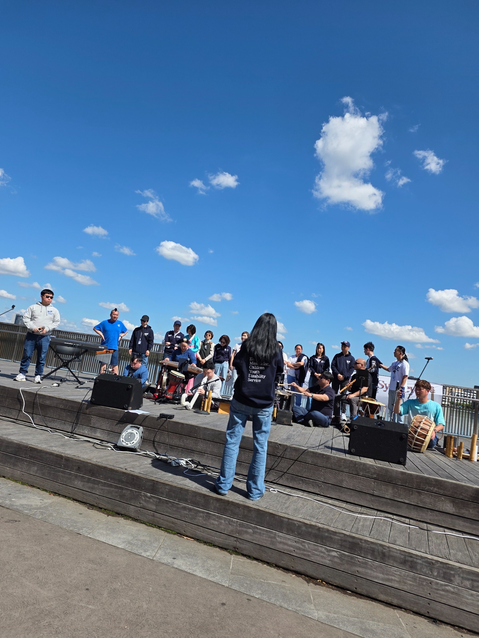 Inclusive musicians and singers performing together on an outdoor community stage