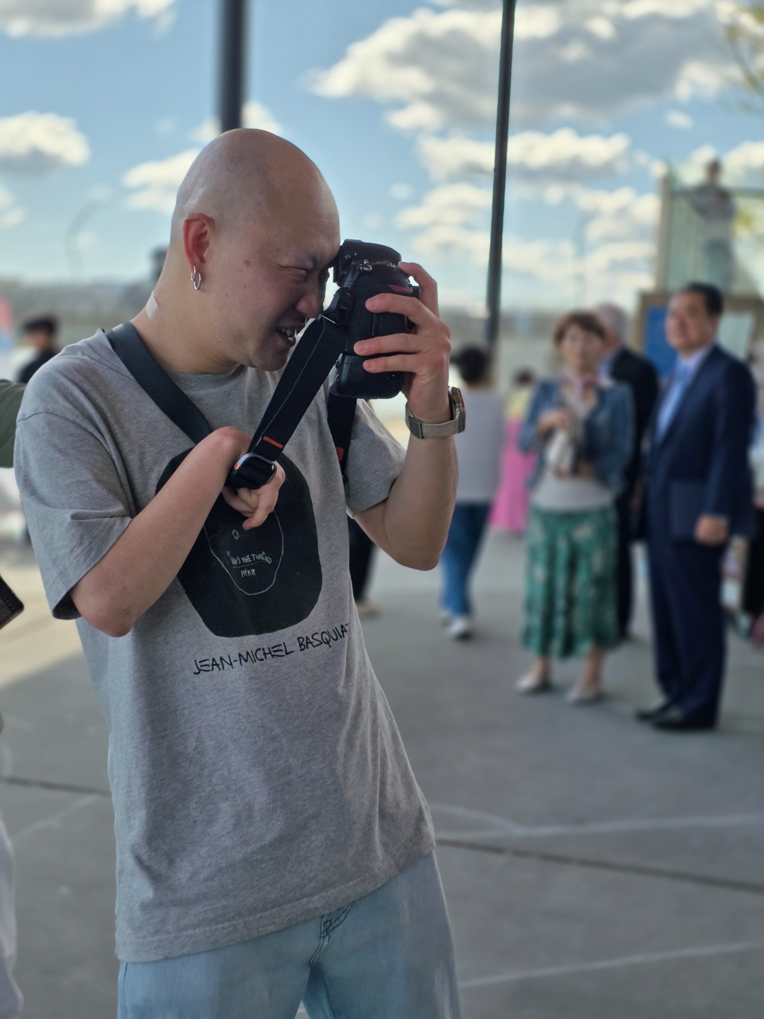 Participant taking photographs at an outdoor community event